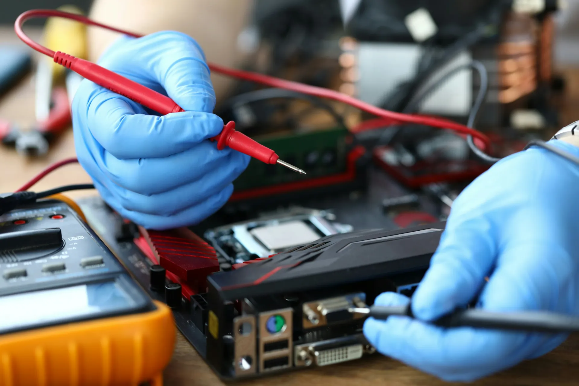 Close-up of an electrician using a multimeter to test connections on a circuit board, demonstrating electrical fault finding and diagnostics.